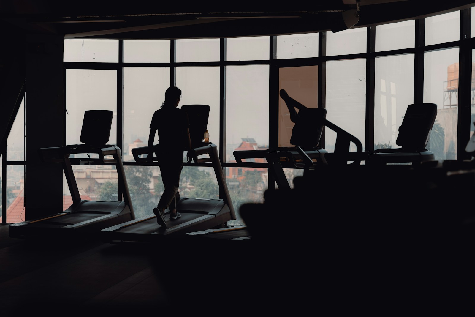 A silhouette of a person on a treadmill